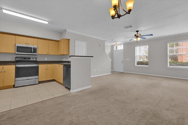 kitchen featuring ceiling fan with notable chandelier, pendant lighting, appliances with stainless steel finishes, crown molding, and light colored carpet