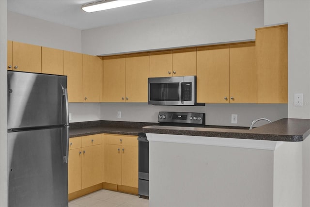 kitchen featuring light brown cabinets, stainless steel appliances, kitchen peninsula, and light tile patterned flooring