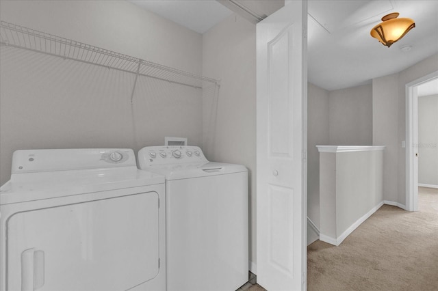 laundry area featuring light carpet and washer and dryer