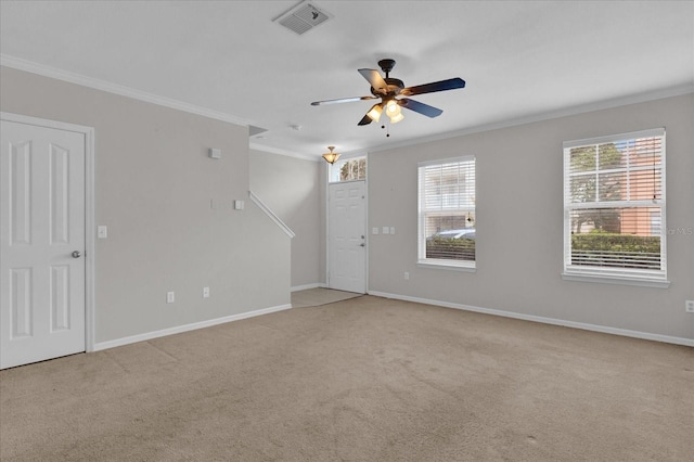 empty room featuring crown molding, ceiling fan, and light colored carpet