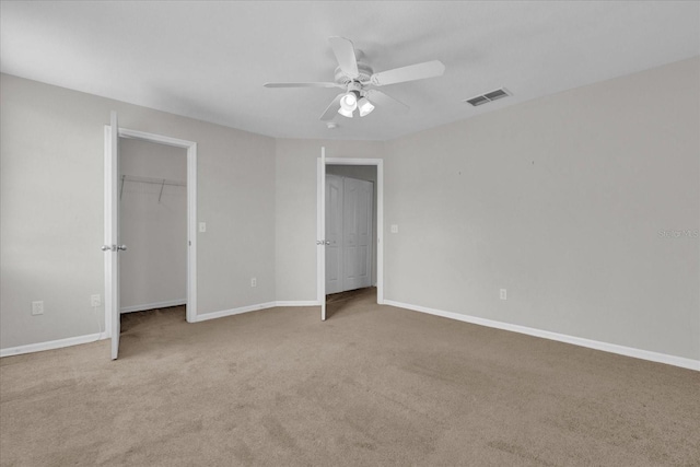 unfurnished bedroom with ceiling fan and light carpet