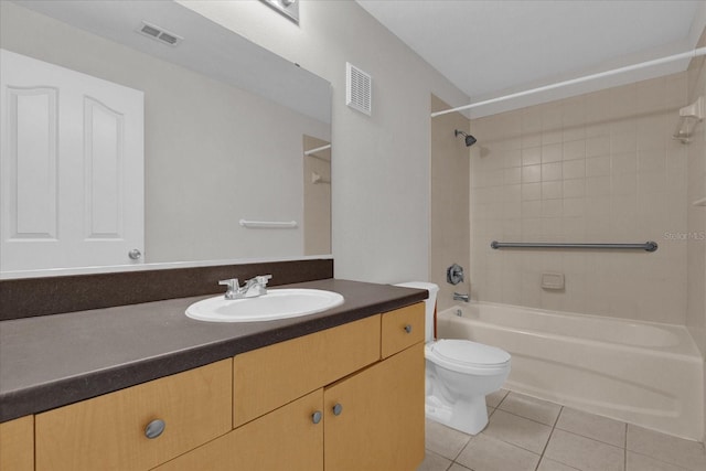 full bathroom featuring tiled shower / bath, vanity, toilet, and tile patterned flooring