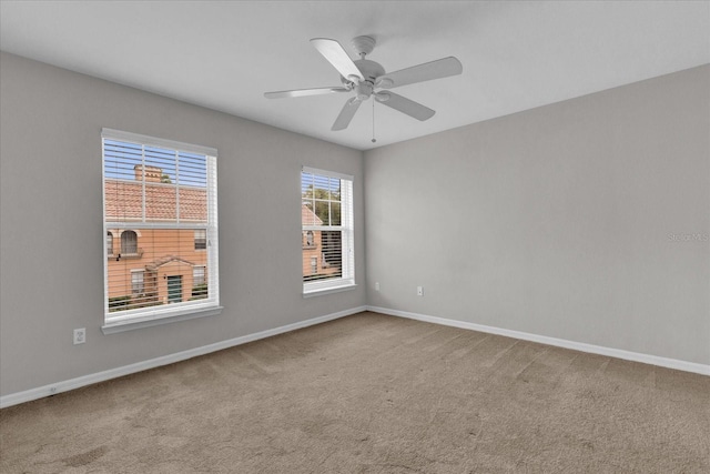 unfurnished room with carpet and ceiling fan