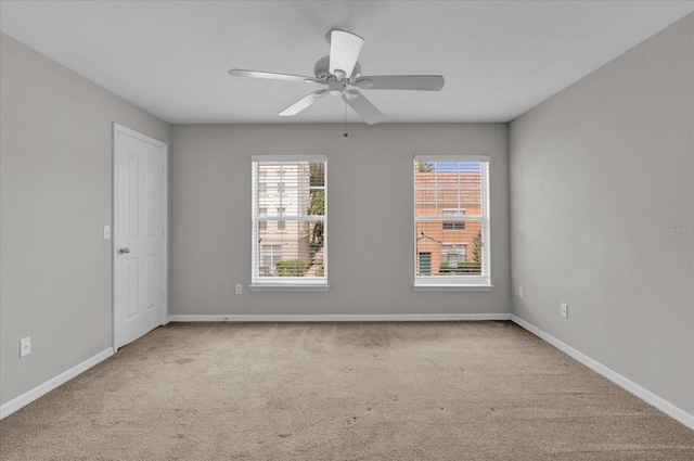 carpeted empty room featuring ceiling fan