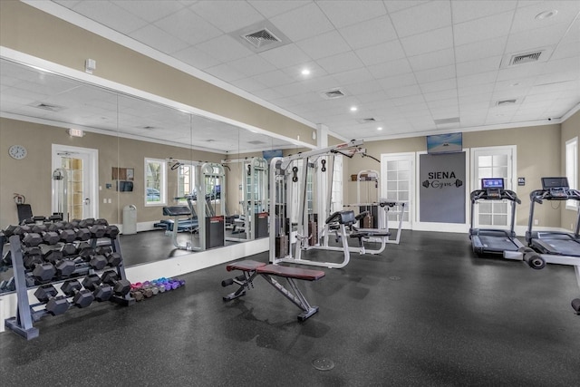 exercise room with a drop ceiling and ornamental molding