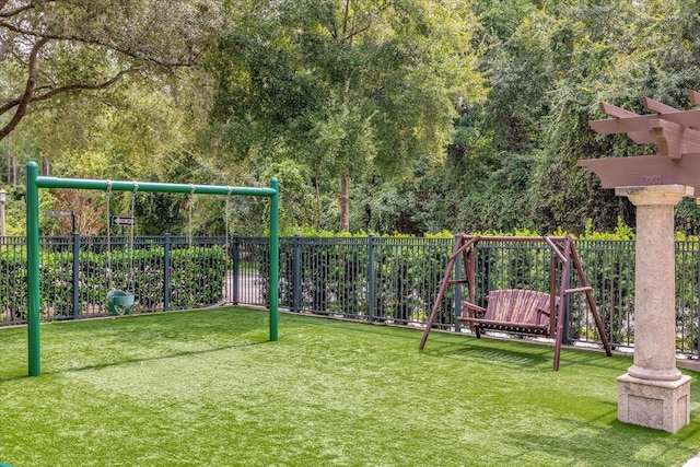 exterior space with a playground and a yard