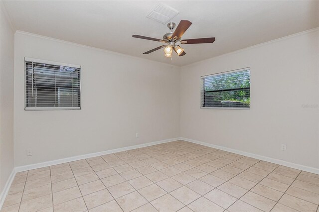 empty room featuring light tile patterned floors, ornamental molding, and ceiling fan