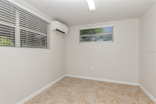 tiled empty room featuring a wall unit AC