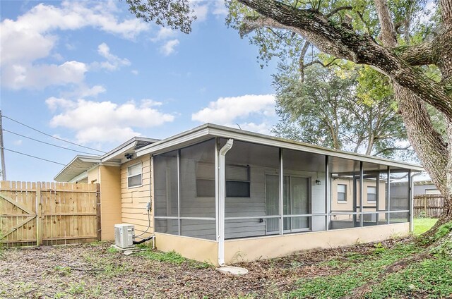 rear view of house featuring a sunroom