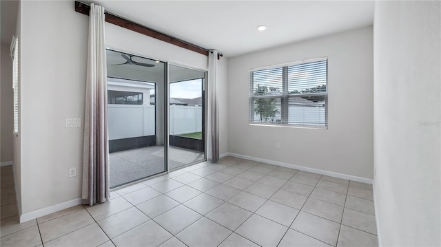 unfurnished room featuring light tile patterned floors and ceiling fan