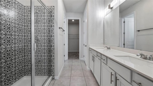 bathroom featuring vanity, tile patterned flooring, and a shower with door