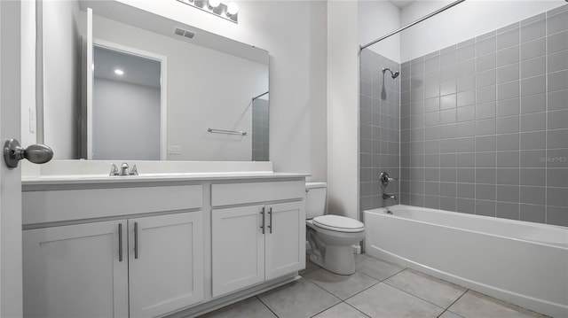 full bathroom featuring tile patterned floors, toilet, vanity, and tiled shower / bath