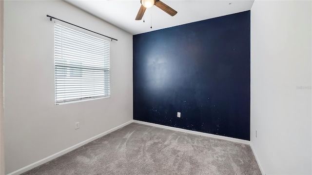 carpeted empty room featuring ceiling fan