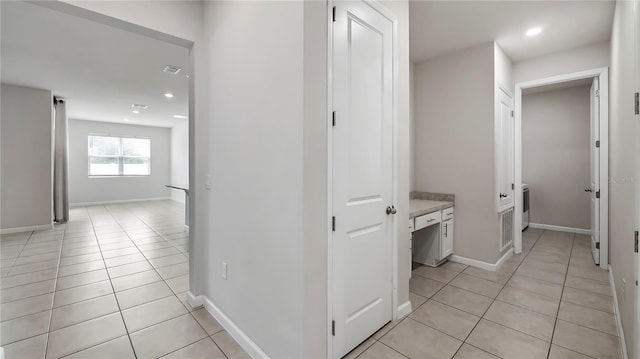 corridor featuring light tile patterned flooring