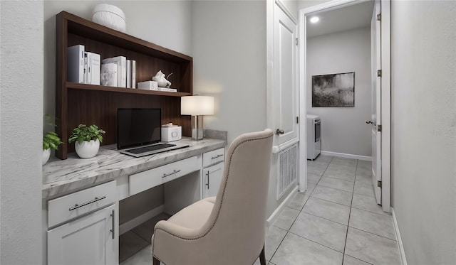 office with built in desk and light tile patterned floors