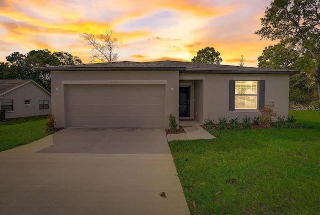 view of front of property with a garage, cooling unit, and a yard