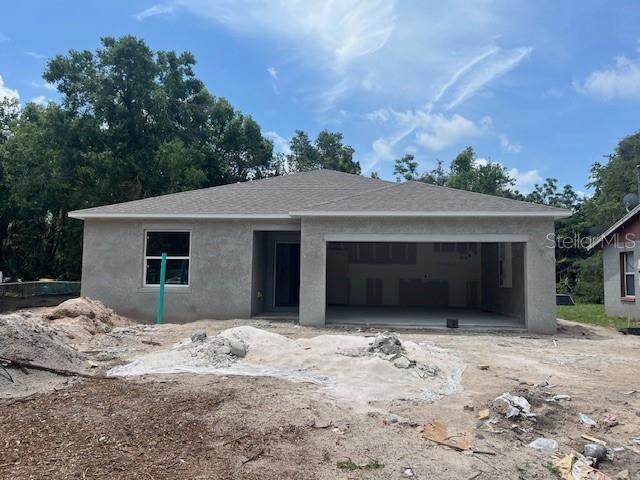 1608 Jefferson Dr, Mount Dora, FL 32757 - property under construction featuring a garage and stucco siding