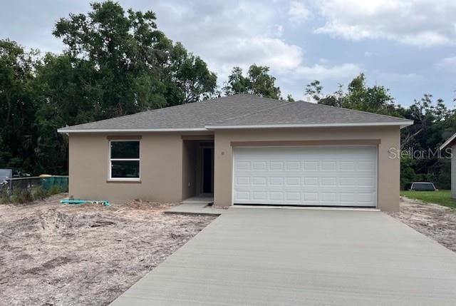 1608 Jefferson Dr, Mount Dora, FL 32757 - view of front of property with driveway, stucco siding, and an attached garage