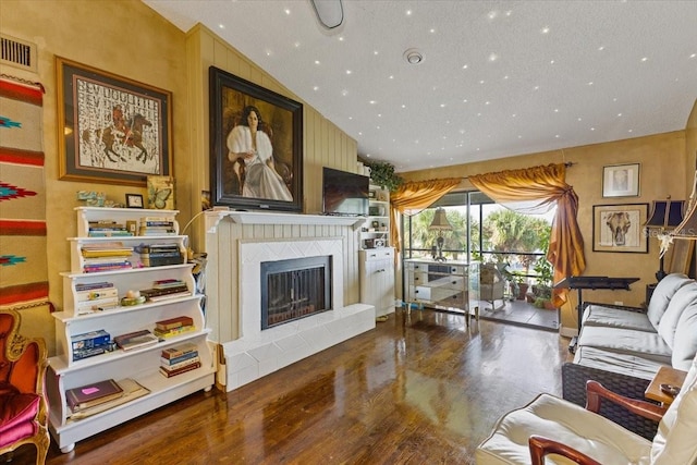 living room with vaulted ceiling and hardwood / wood-style floors