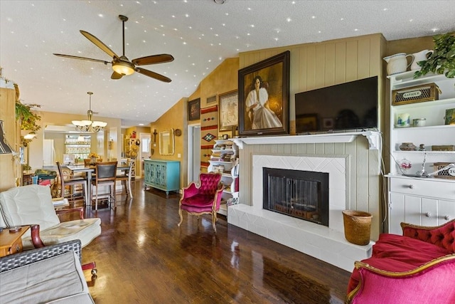 living room with ceiling fan, a textured ceiling, dark wood-type flooring, and high vaulted ceiling