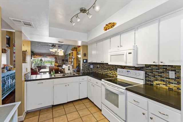 kitchen with white cabinets, backsplash, white appliances, light tile patterned floors, and sink