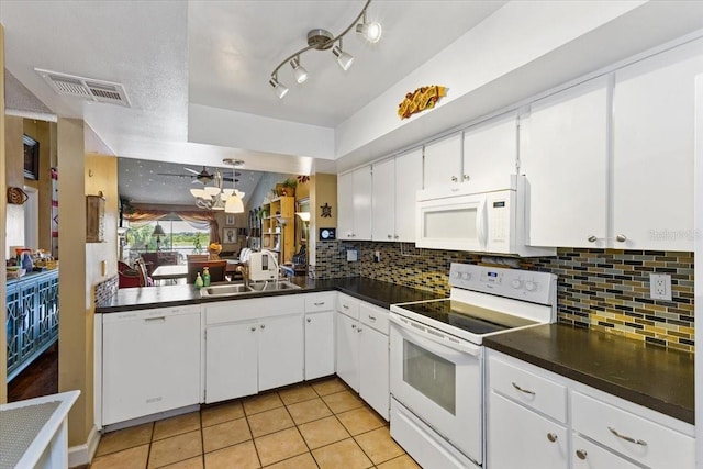 4113 Fairview Vista Pt Unit 308, Orlando, FL 32804 - kitchen with white appliances, dark countertops, a sink, and backsplash