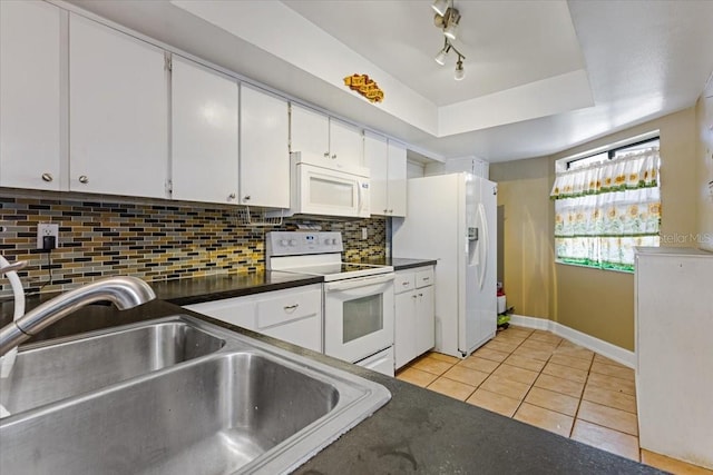 kitchen with white cabinets, light tile patterned floors, sink, white appliances, and backsplash