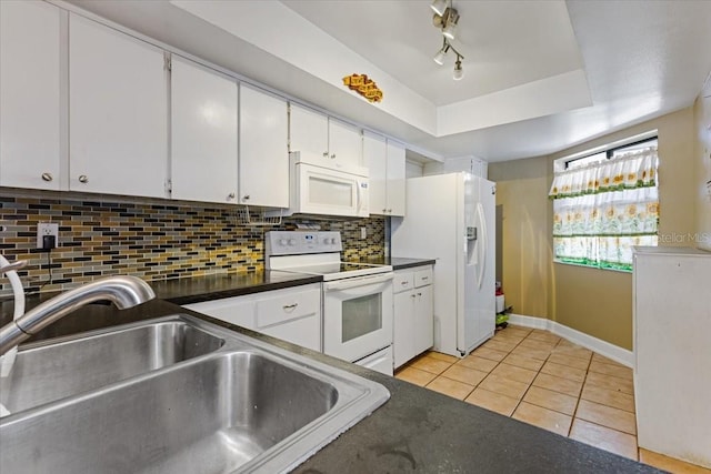 4113 Fairview Vista Pt Unit 308, Orlando, FL 32804 - kitchen featuring white appliances, a sink, light tile patterned flooring, white cabinetry, and backsplash