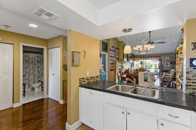 kitchen featuring white cabinetry, dark hardwood / wood-style floors, white dishwasher, and sink