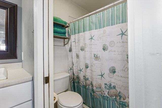 4113 Fairview Vista Pt Unit 308, Orlando, FL 32804 - bathroom featuring toilet, vanity, tile walls, and curtained shower