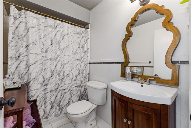 bathroom featuring tile walls, tile patterned flooring, vanity, and toilet