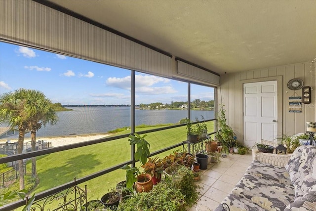 sunroom / solarium featuring a water view