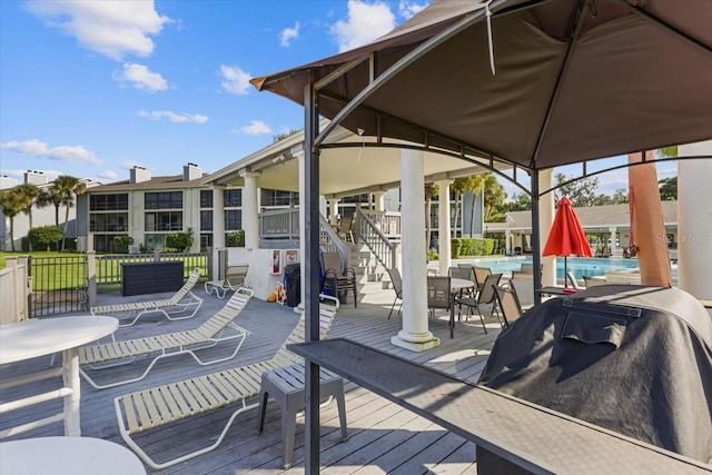 wooden deck featuring a community pool