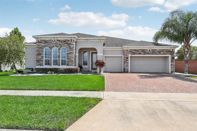 view of front of property featuring a front yard and a garage