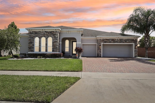 view of front of property featuring a lawn and a garage