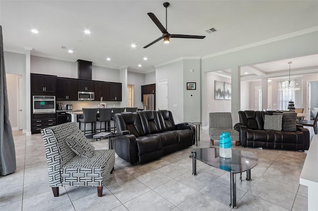 living room with light tile patterned flooring, ceiling fan with notable chandelier, and ornamental molding