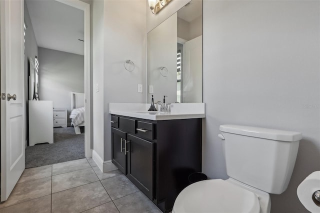 bathroom featuring vanity, toilet, and tile patterned floors