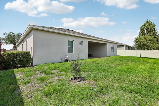 back of house featuring a yard