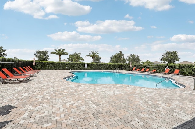 view of swimming pool with a patio