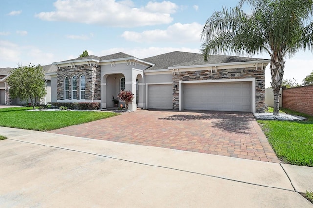 view of front of home featuring a garage and a front lawn