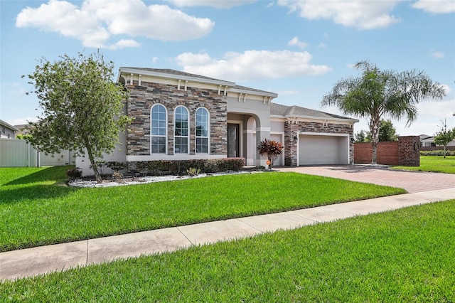 view of front of home with a front yard and a garage