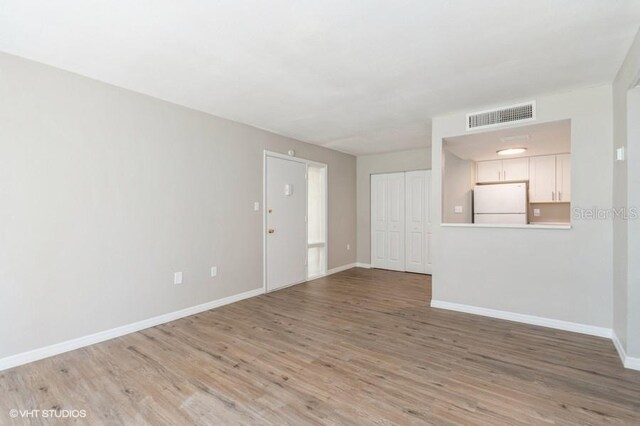 unfurnished living room with hardwood / wood-style floors