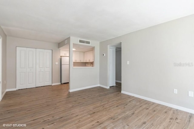 unfurnished living room with light wood-type flooring