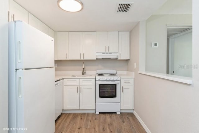 kitchen with white cabinets, white appliances, and sink