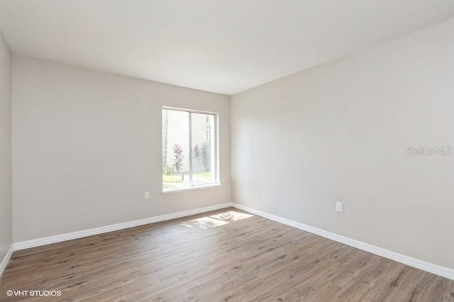 unfurnished room with wood-type flooring