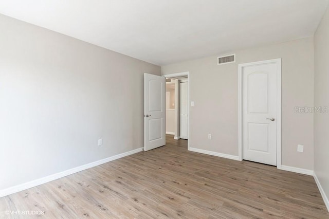 unfurnished bedroom featuring light wood-type flooring