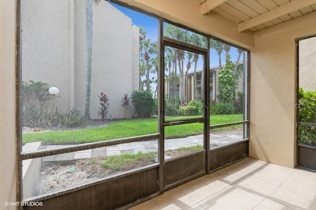 unfurnished sunroom with wooden ceiling and beam ceiling