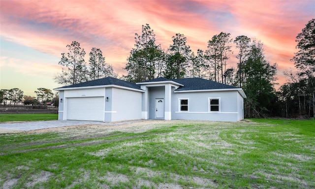 view of front of house featuring a lawn and a garage