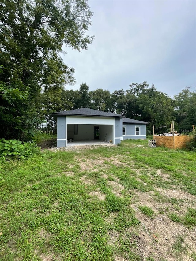 rear view of property featuring a yard