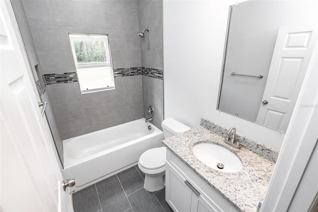 full bathroom featuring vanity, toilet, and tiled shower / bath